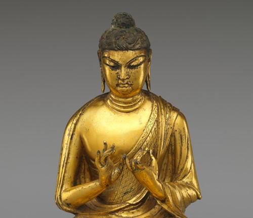 Closeup of a gold colored Buddha sculpture