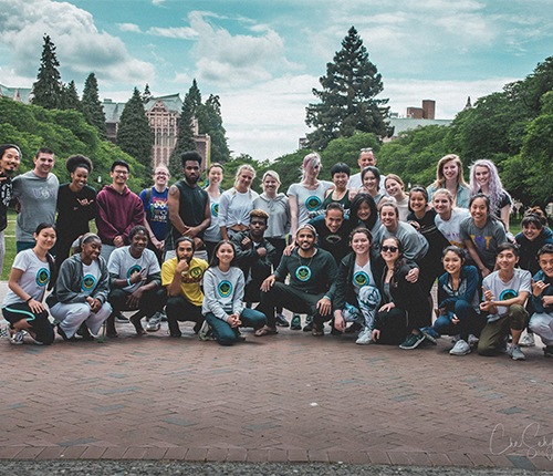 Capoeira group posed for group photo outside of a UW building