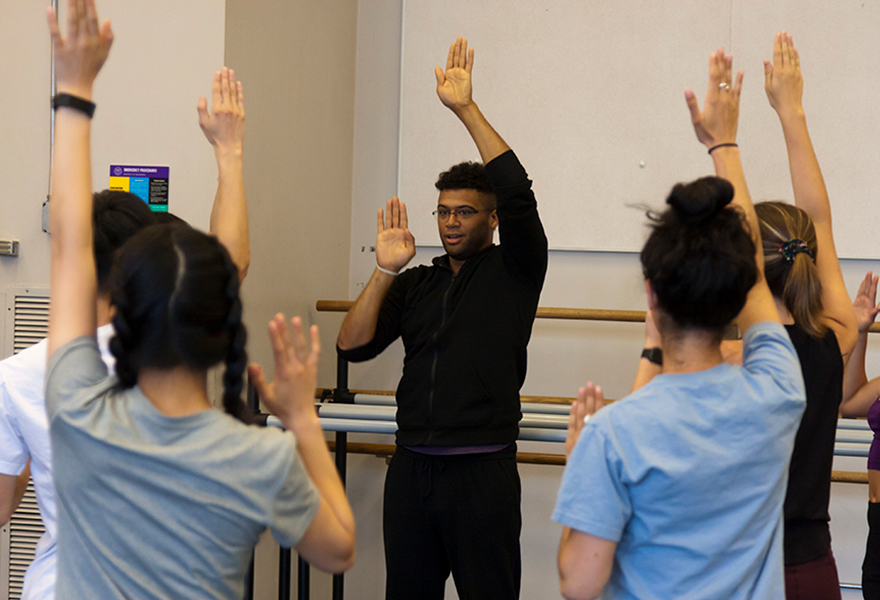 Students standing in studio space practicing dance