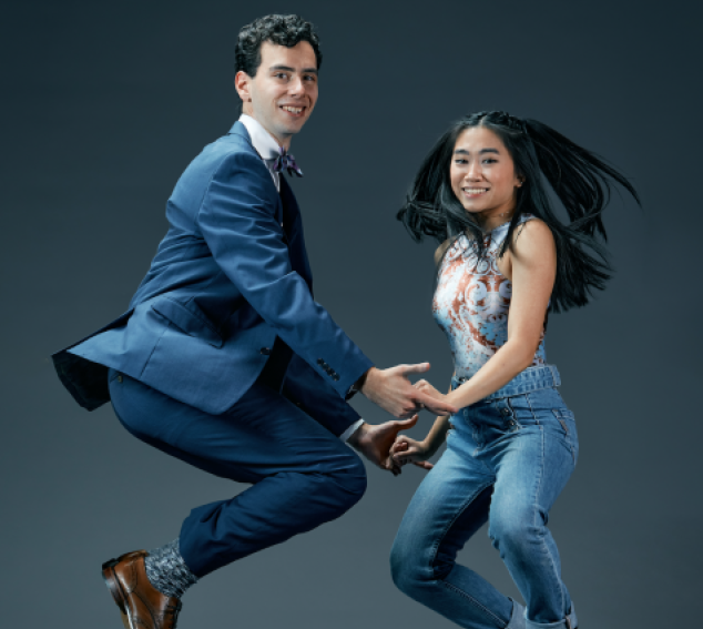 Two swing dancers jump