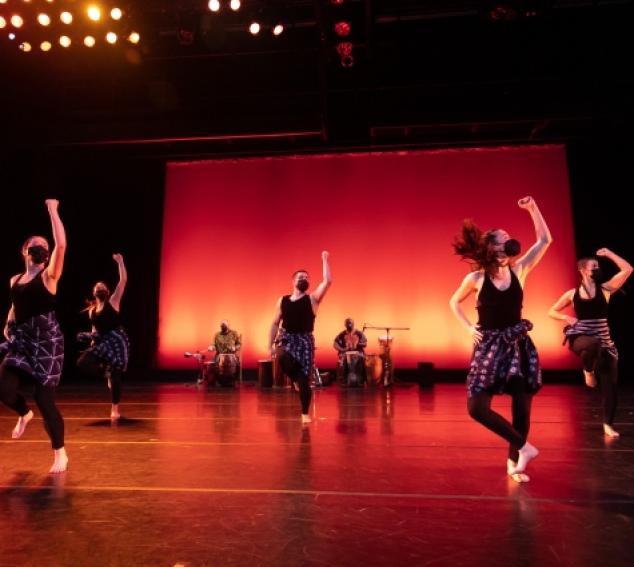 students dancing west African dance on stage