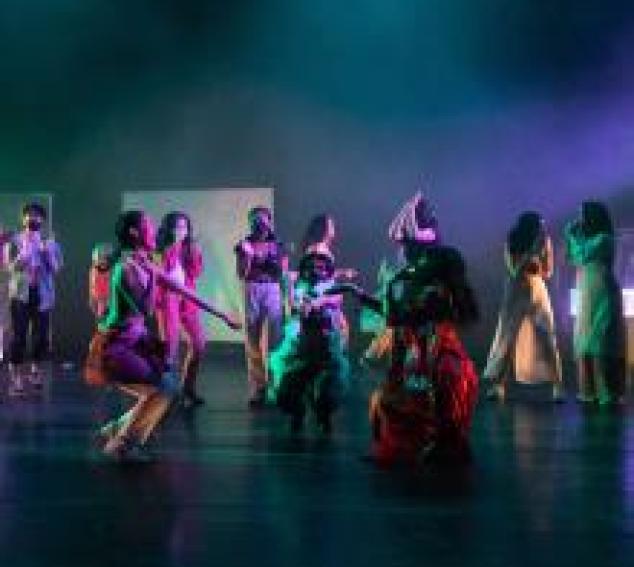 Dancers is brightly colored outfits 
