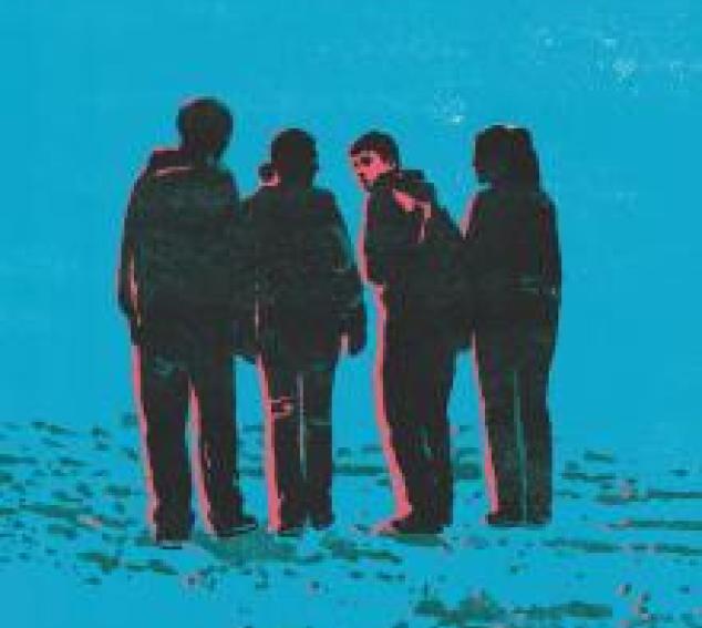 Four people walking, one looking back