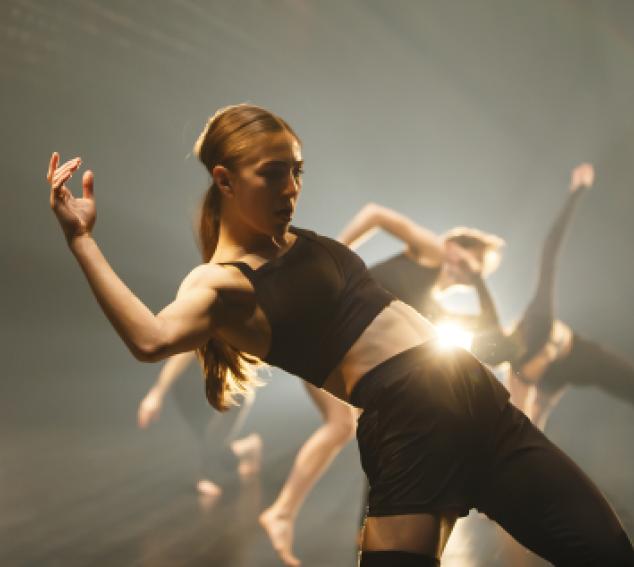 RUBBERBAND Restless Underdog: dancers in black on backlit stage