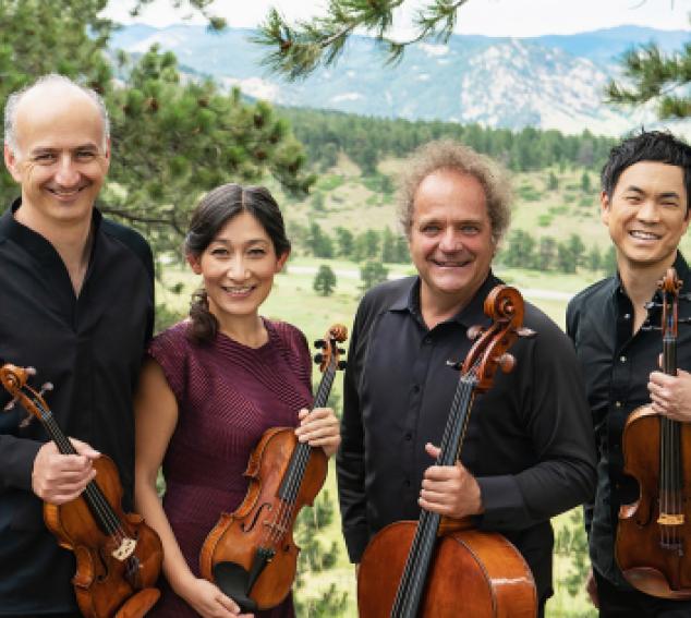Four musicians pose with their string instruments in front of a nature scene